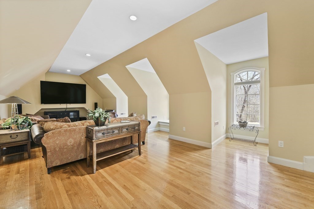 19 Whippoorwill Lane Concord, MA 01742 - Photo 24 of 33 a living room with furniture and a flat screen tv