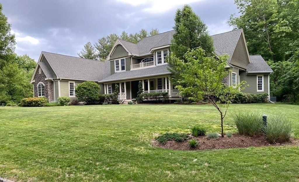 19 Whippoorwill Lane Concord, MA 01742 - Photo 29 of 33 a front view of a house with a yard table and chairs