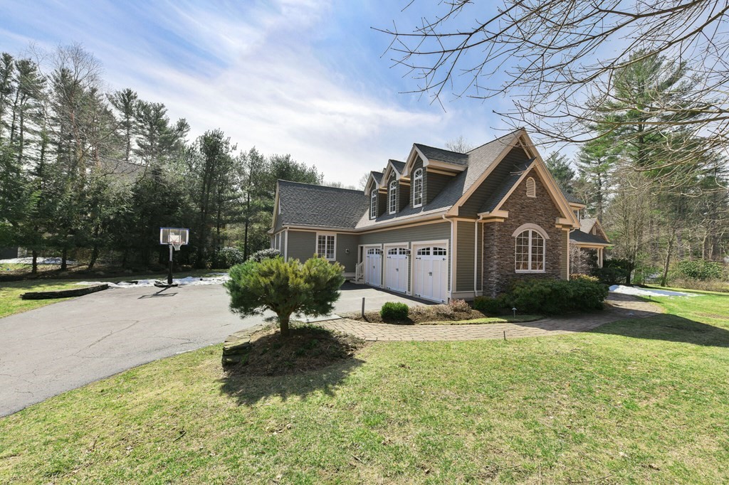 19 Whippoorwill Lane Concord, MA 01742 - Photo 33 of 33 a front view of a house with a yard and garage
