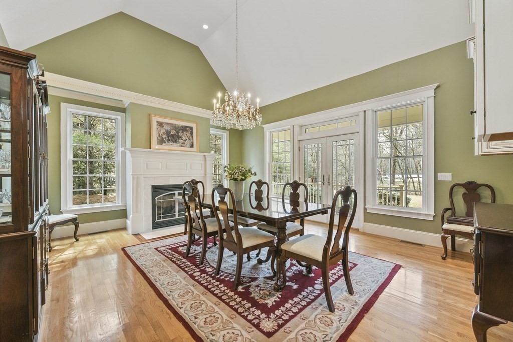 19 Whippoorwill Lane Concord, MA 01742 - Photo 8 of 33 a view of a dining room with furniture a chandelier and wooden floor