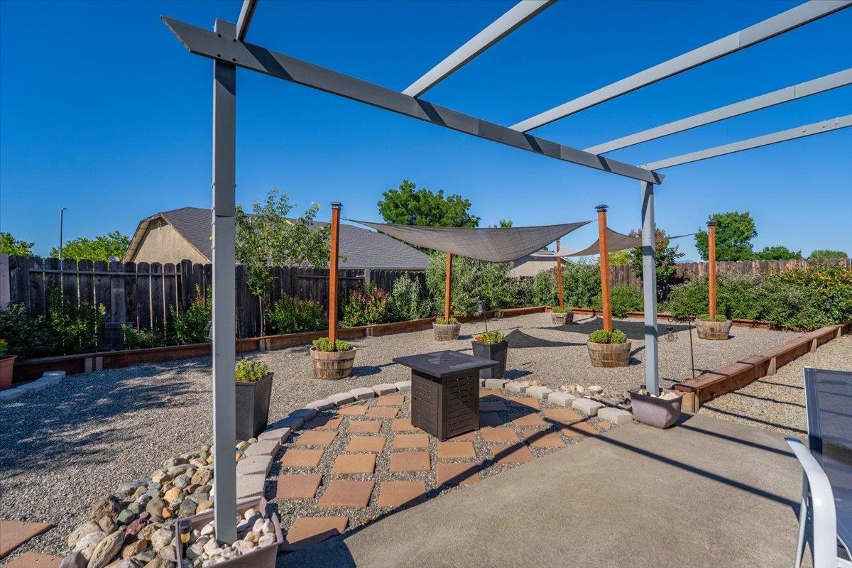 2110 Gentry Way Red Bluff, CA 96080 - Photo 36 of 47 a view of a patio with a table and chairs and potted plants