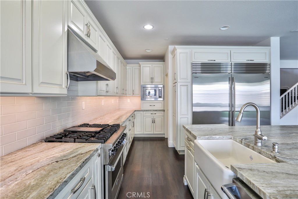2795 Devonshire Lane Ontario, CA 91762 - Photo 16 of 50 a kitchen with a sink stove top oven and refrigerator