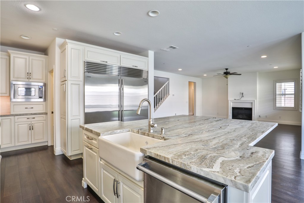 2795 Devonshire Lane Ontario, CA 91762 - Photo 17 of 50 a kitchen with kitchen island a sink appliances and a counter top space
