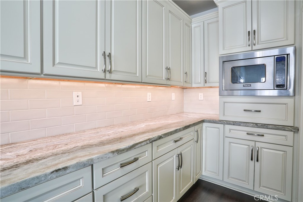 2795 Devonshire Lane Ontario, CA 91762 - Photo 19 of 50 a kitchen with granite countertop white cabinets and white appliances