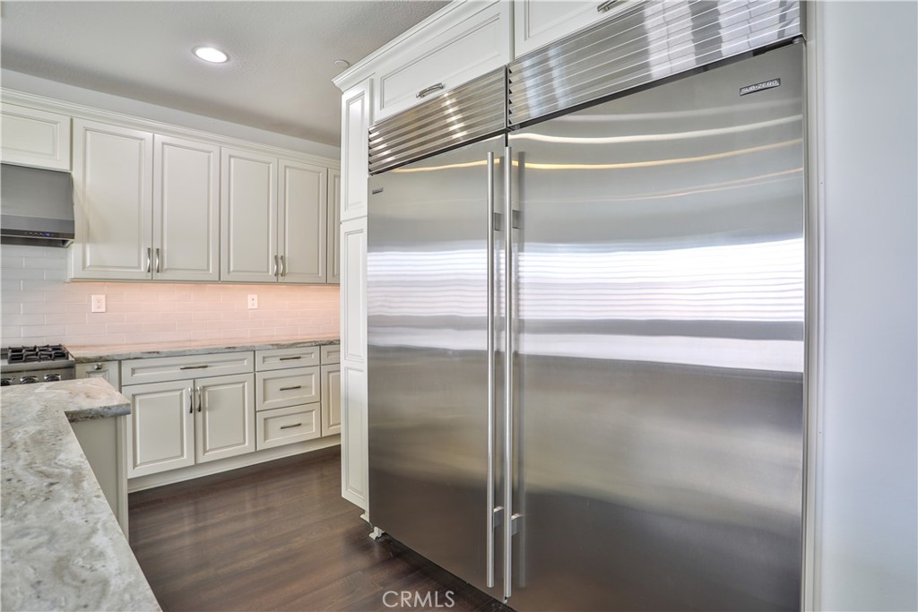 2795 Devonshire Lane Ontario, CA 91762 - Photo 21 of 50 a kitchen with cabinets and a refrigerator