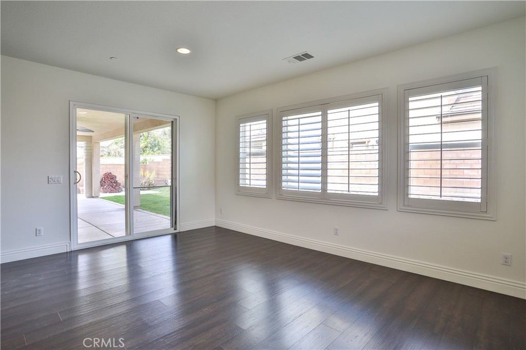 2795 Devonshire Lane Ontario, CA 91762 - Photo 23 of 50 an empty room with wooden floor and windows