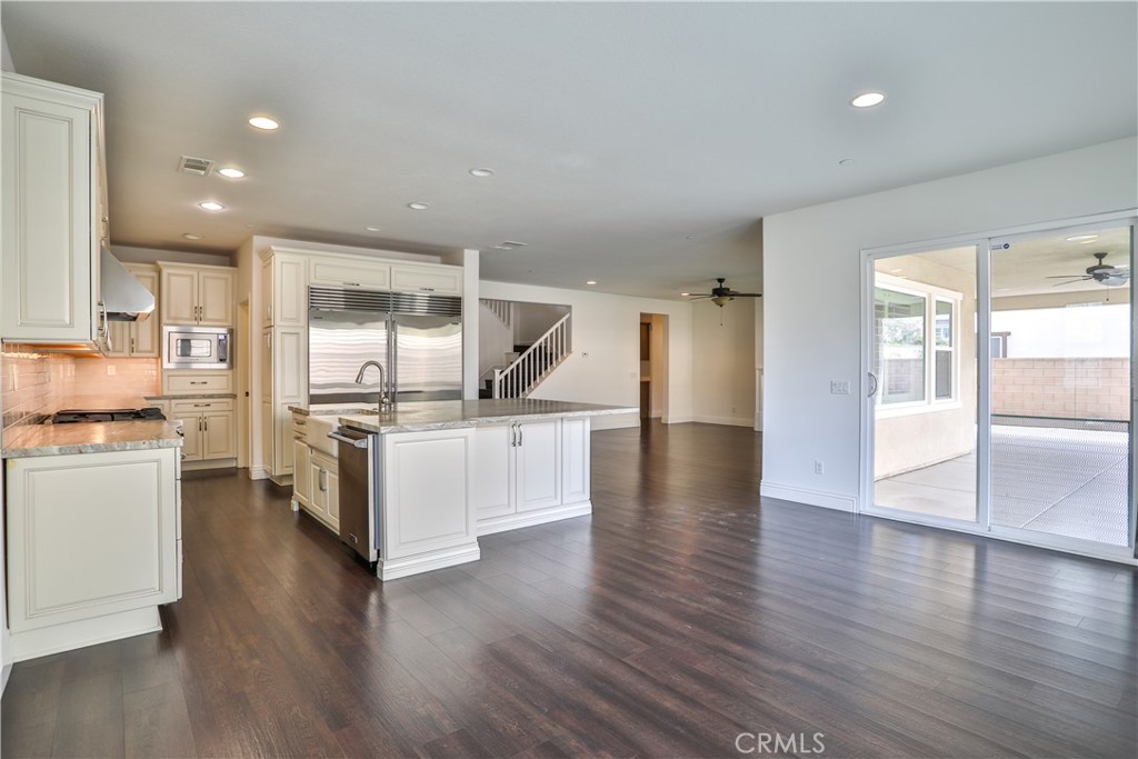 2795 Devonshire Lane Ontario, CA 91762 - Photo 25 of 50 a kitchen with a refrigerator and a stove top oven