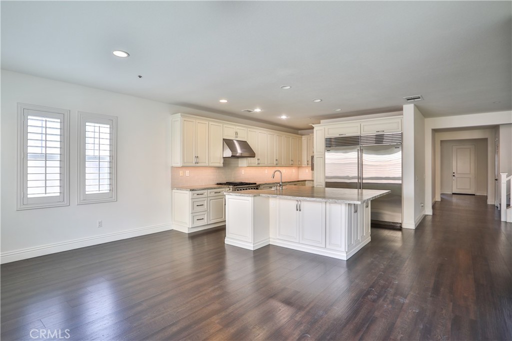 2795 Devonshire Lane Ontario, CA 91762 - Photo 26 of 50 a kitchen with a white wooden cabinets wooden floor and a window