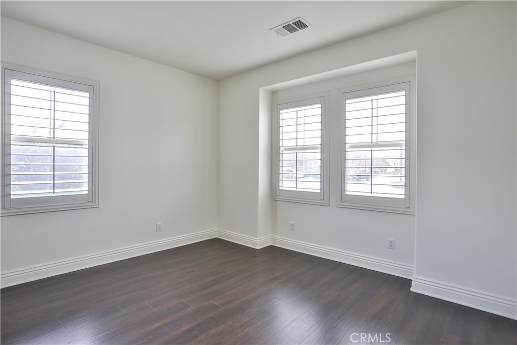 2795 Devonshire Lane Ontario, CA 91762 - Photo 27 of 50 an empty room with wooden floor and windows