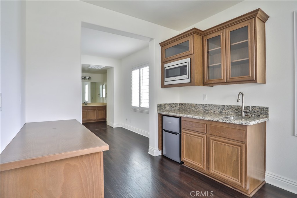 2795 Devonshire Lane Ontario, CA 91762 - Photo 29 of 50 a kitchen with a sink cabinets and wooden floor