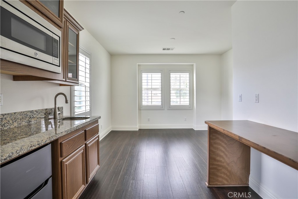 2795 Devonshire Lane Ontario, CA 91762 - Photo 30 of 50 a kitchen with granite countertop a sink a stove and wooden floor