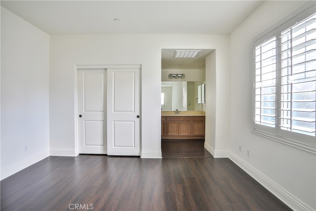 2795 Devonshire Lane Ontario, CA 91762 - Photo 31 of 50 an empty room with wooden floor and windows