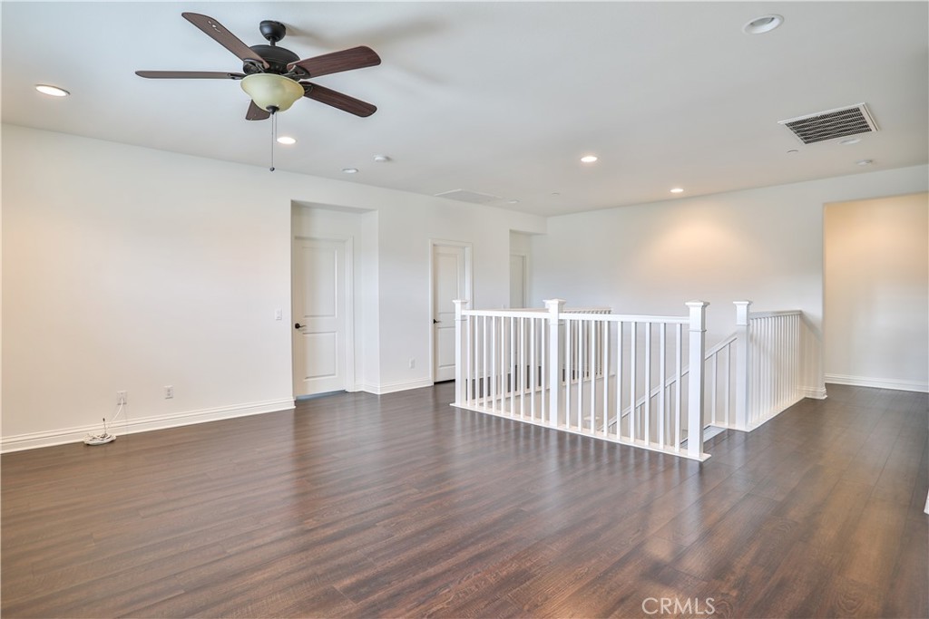 2795 Devonshire Lane Ontario, CA 91762 - Photo 37 of 50 a view of an empty room with wooden floor and a ceiling fan