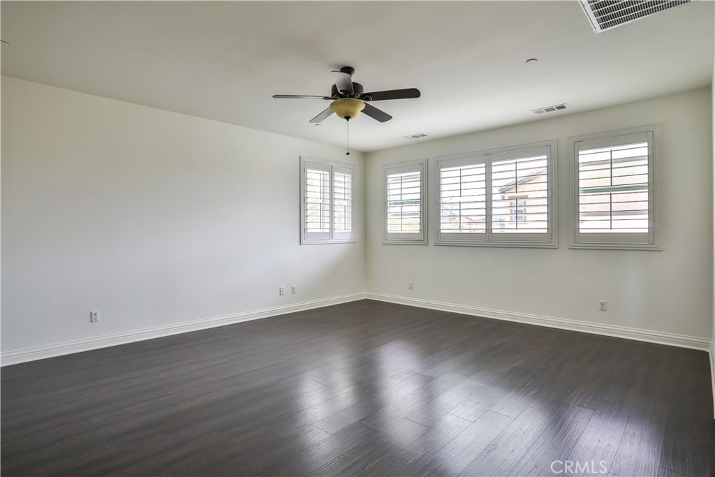2795 Devonshire Lane Ontario, CA 91762 - Photo 38 of 50 an empty room with wooden floor and windows