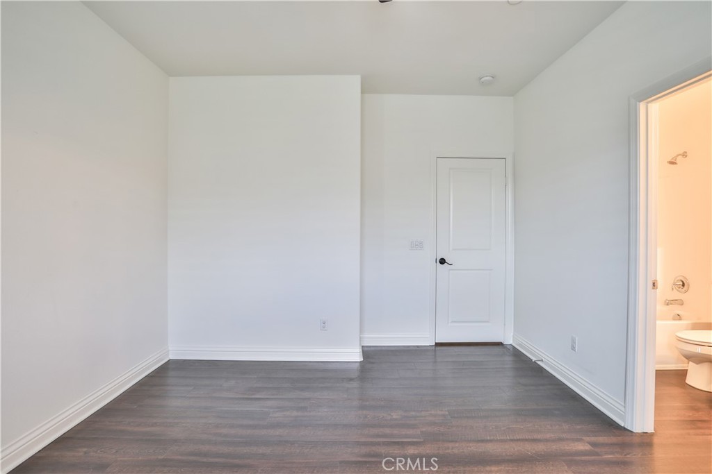 2795 Devonshire Lane Ontario, CA 91762 - Photo 40 of 50 a view of an empty room with wooden floor and a window
