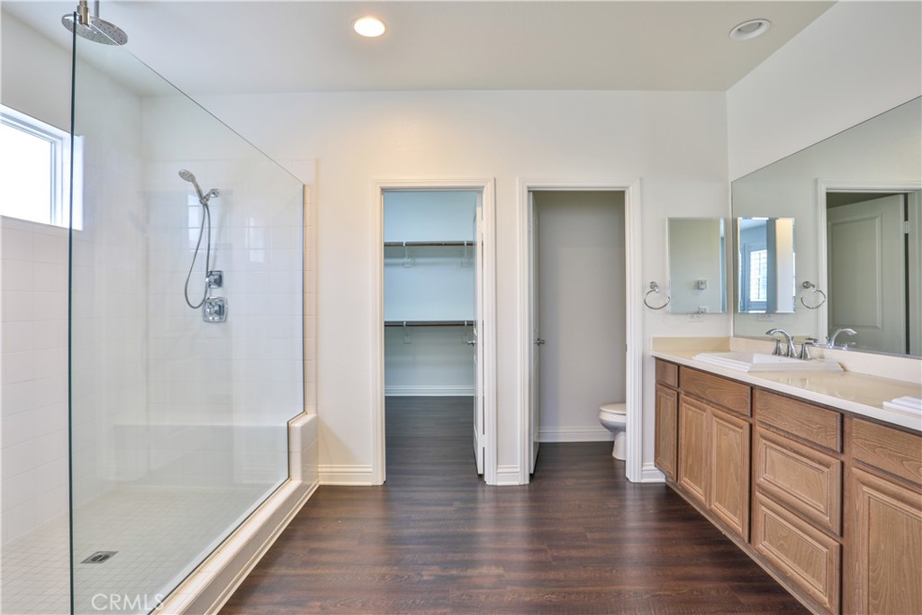 2795 Devonshire Lane Ontario, CA 91762 - Photo 41 of 50 a bathroom with a double vanity sink a large mirror and a bathtub