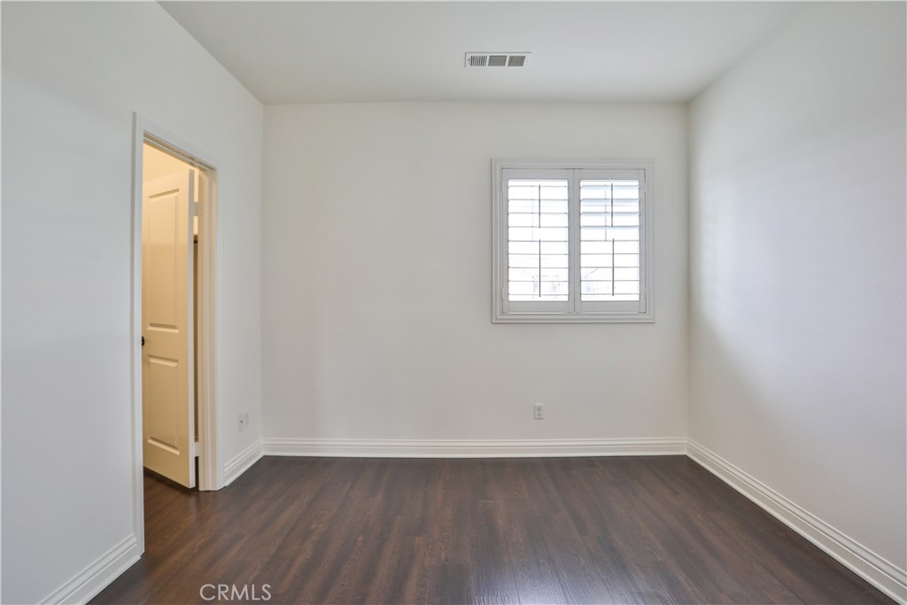 2795 Devonshire Lane Ontario, CA 91762 - Photo 43 of 50 an empty room with wooden floor and windows