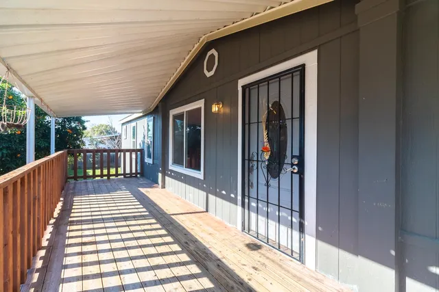 a view of kitchen with granite countertop white cabinets and a refrigerator