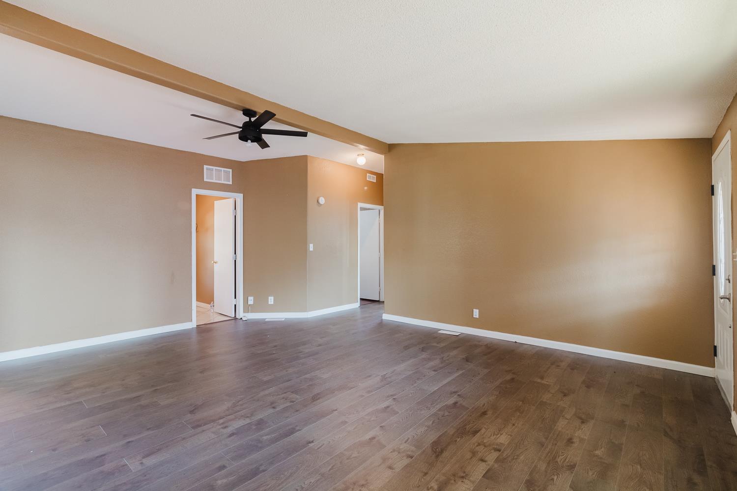216 California Loop Sacramento, CA 95823 - Photo 13 of 42 a view of an empty room with wooden floor