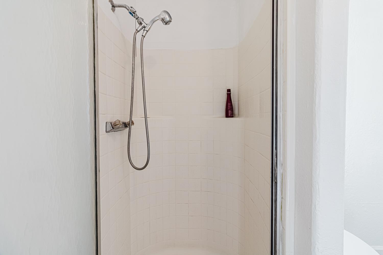 216 California Loop Sacramento, CA 95823 - Photo 19 of 42 a bathroom with a glass shower door