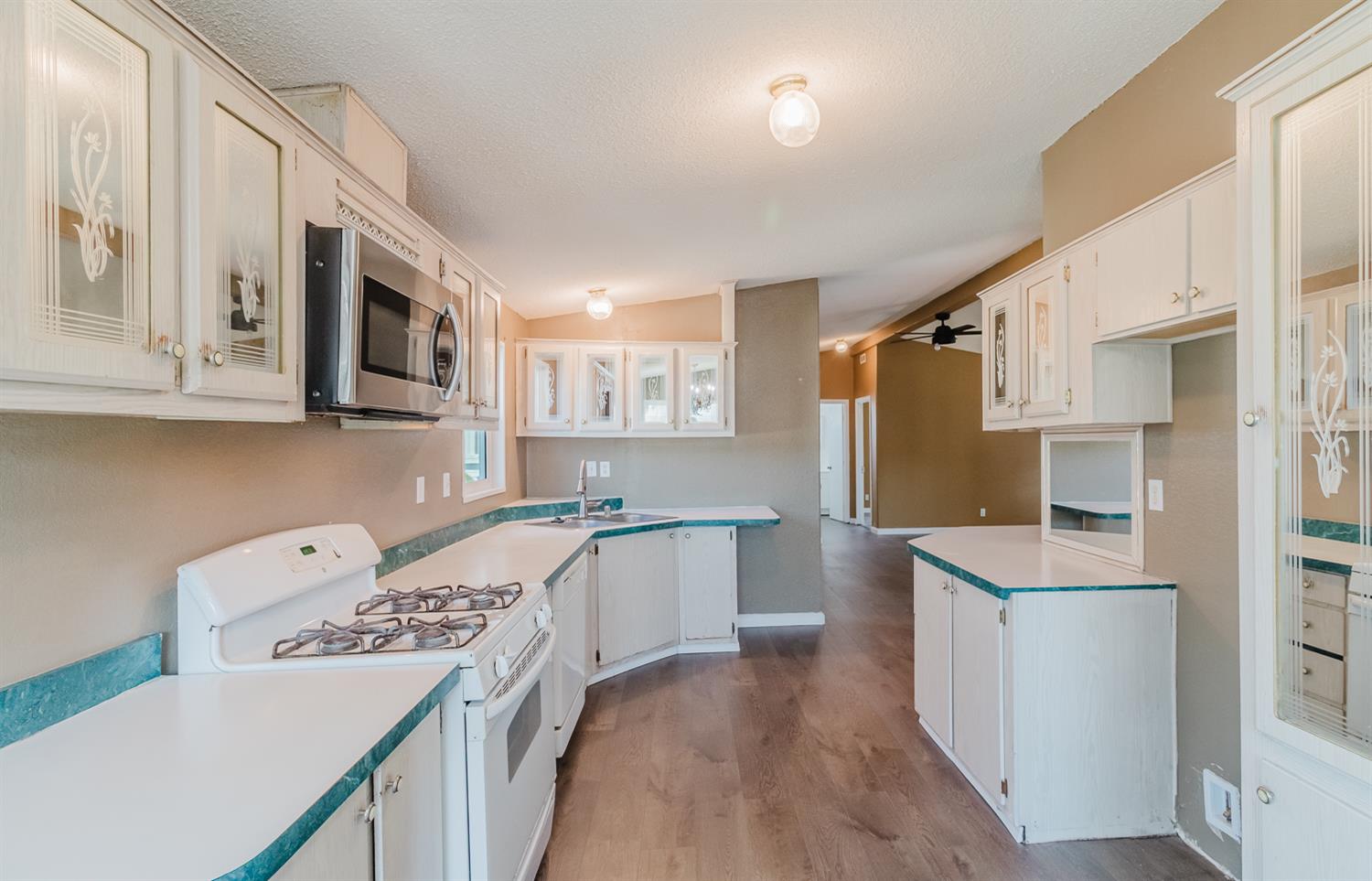 216 California Loop Sacramento, CA 95823 - Photo 25 of 42 a kitchen with a sink a stove a refrigerator and cabinets