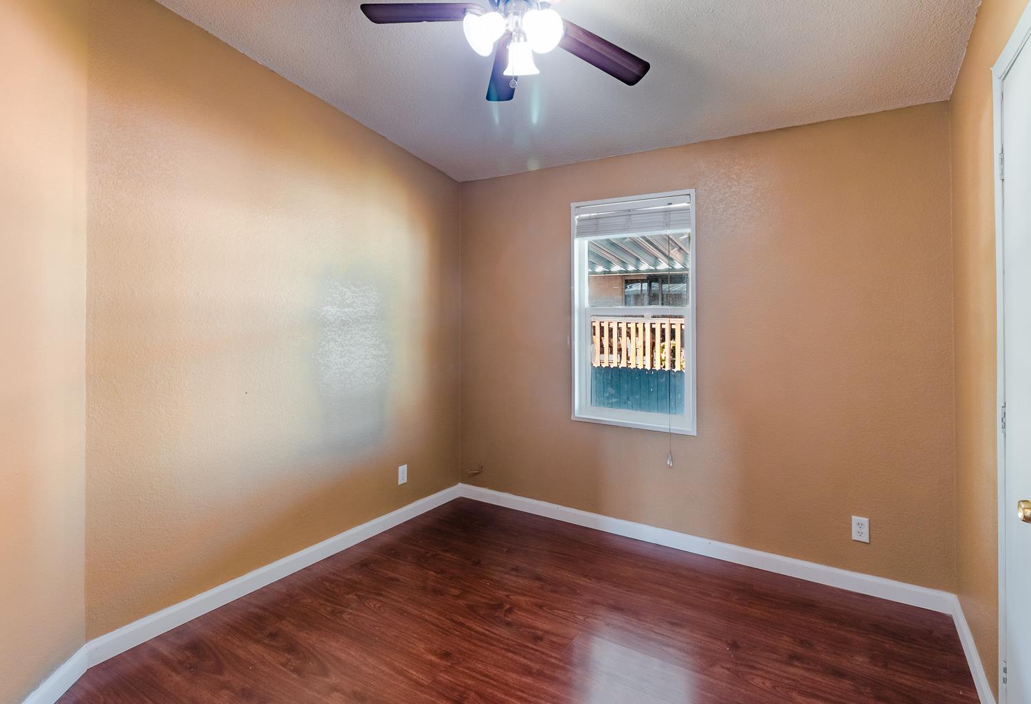 216 California Loop Sacramento, CA 95823 - Photo 33 of 42 a view of an empty room with wooden floor and a window