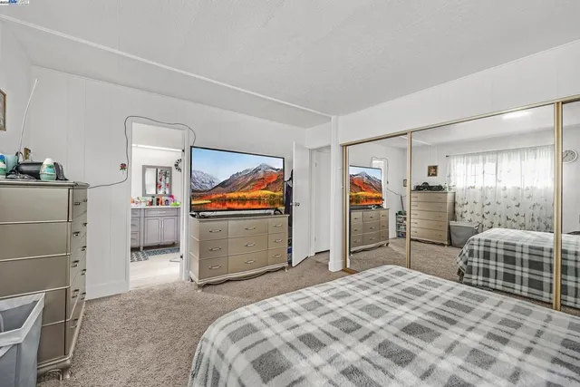 a bedroom with bed and cabinets