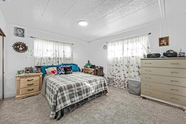 a bedroom with a bed and dresser