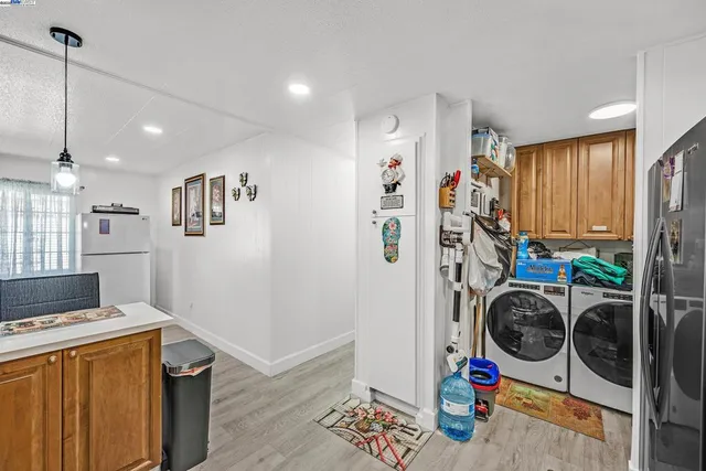 a view of a storage and utility room with washer and dryer