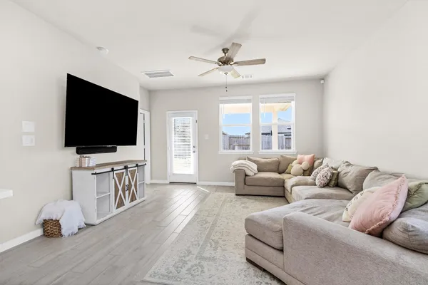 a living room with furniture and a flat screen tv