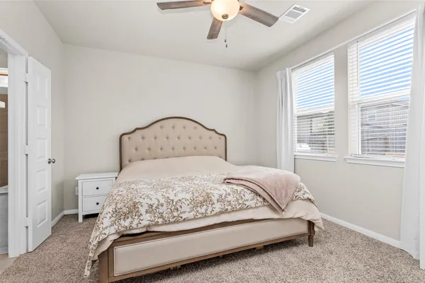 a bedroom with a bed and window