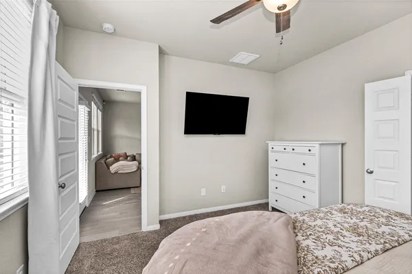 a bedroom with a bed and a flat screen tv