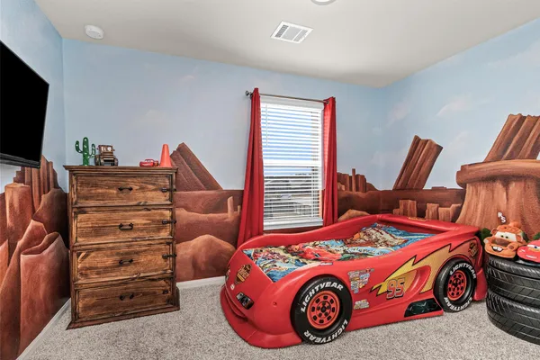 a bedroom with a bed and a television