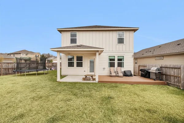 a view of a house with a yard and sitting area