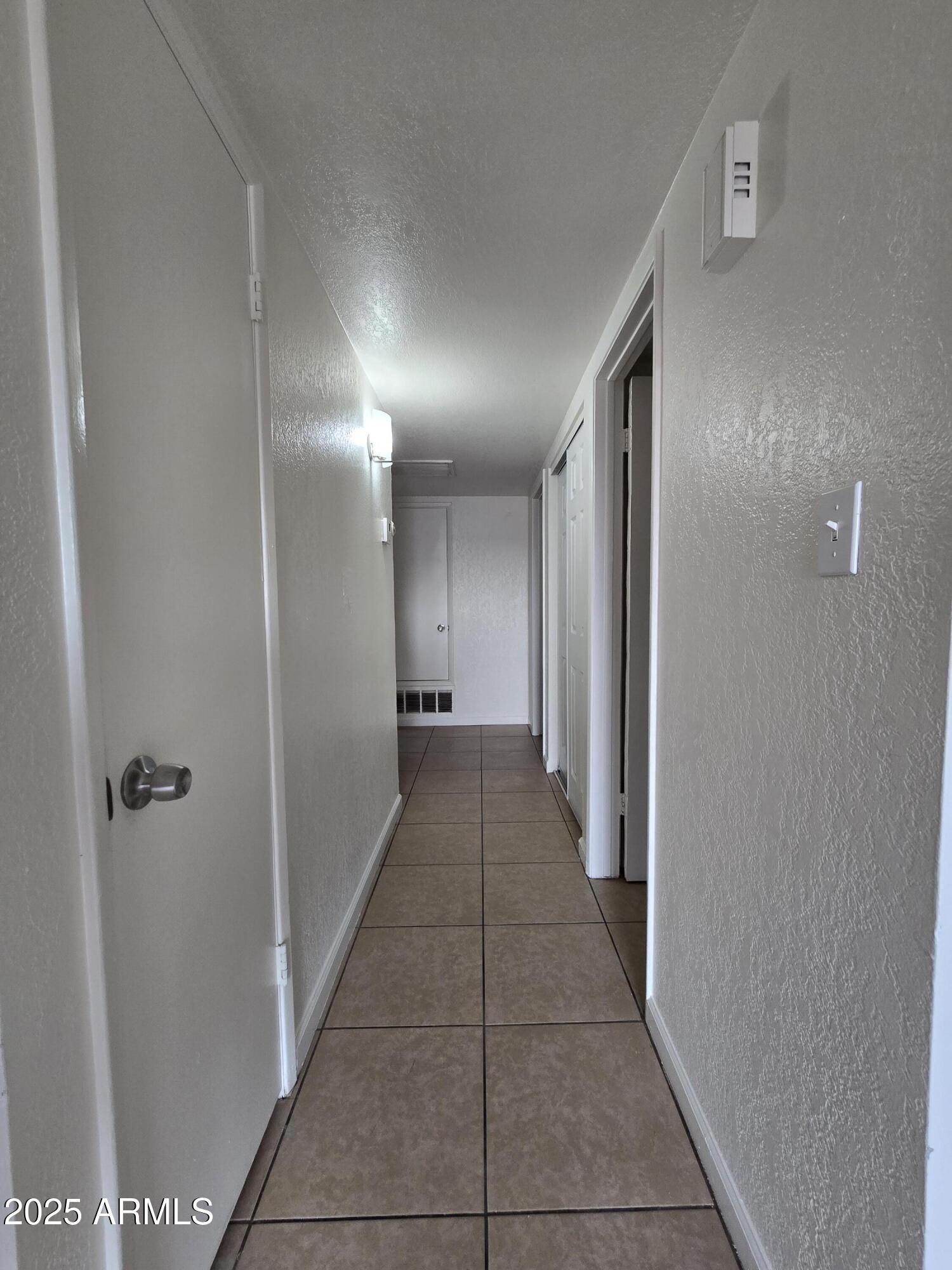 7752 West Flower Street Phoenix, AZ 85033 - Photo 13 of 30 a view of a hallway with a door