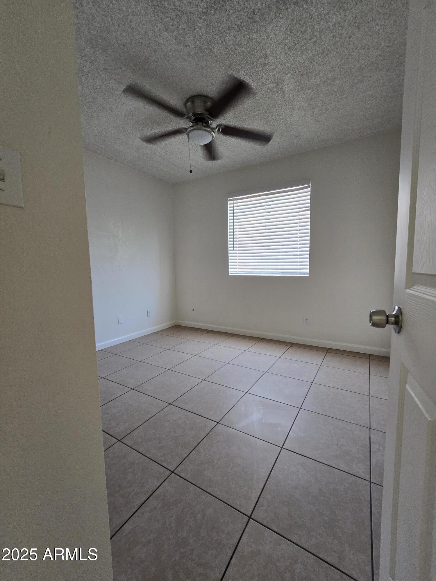 7752 West Flower Street Phoenix, AZ 85033 - Photo 16 of 30 an empty room with windows