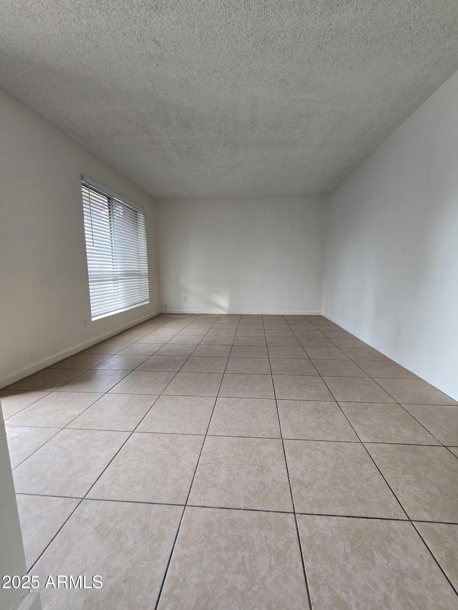 7752 West Flower Street Phoenix, AZ 85033 - Photo 4 of 30 a view of an empty room and window