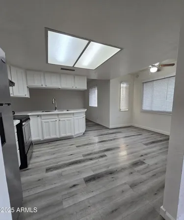 a view of kitchen with furniture and wooden floor