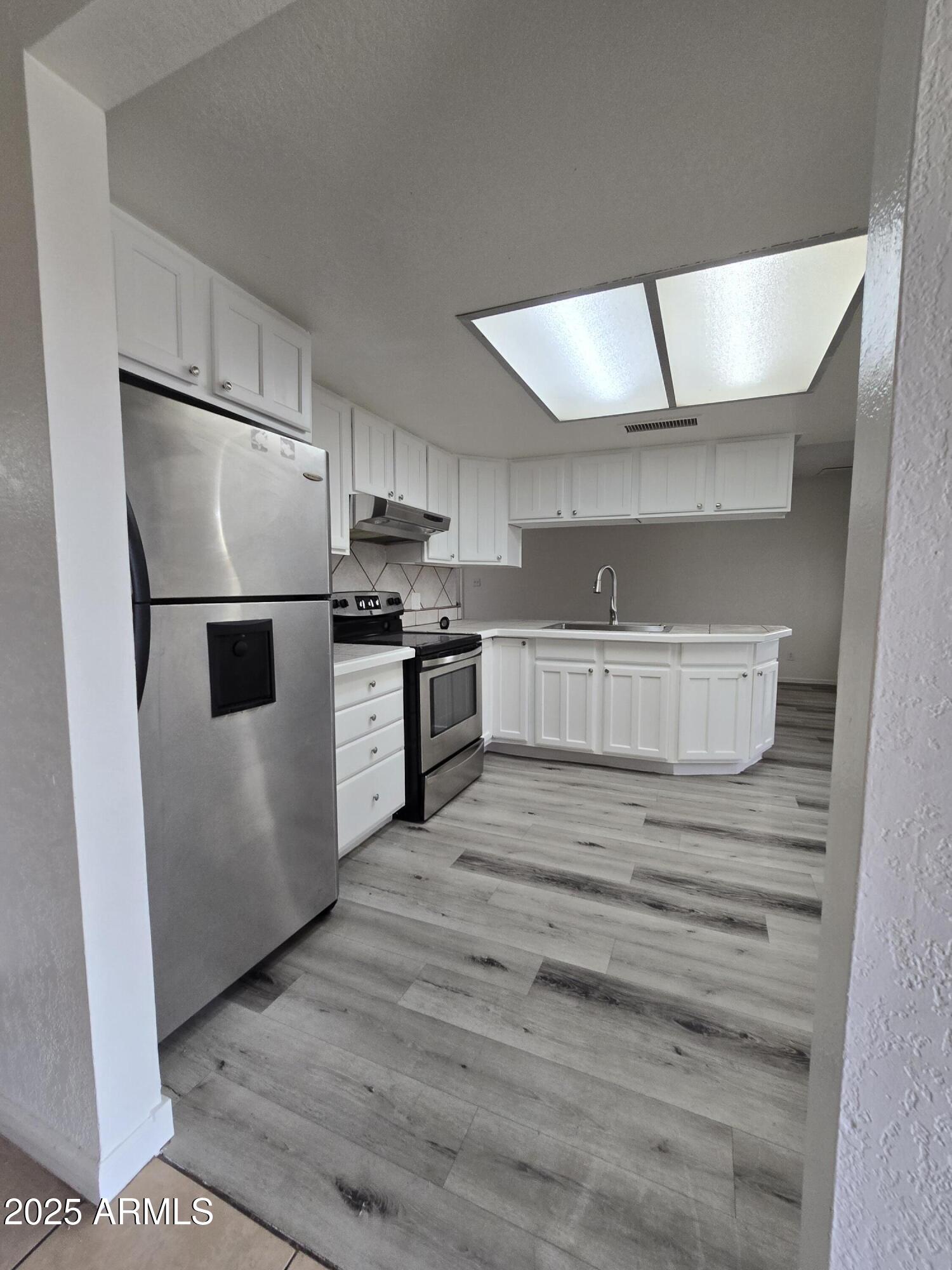 7752 West Flower Street Phoenix, AZ 85033 - Photo 6 of 30 a kitchen with stainless steel appliances granite countertop a refrigerator and a stove