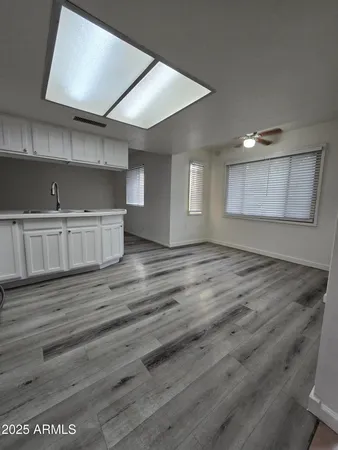 an empty room with wooden floor and cabinet