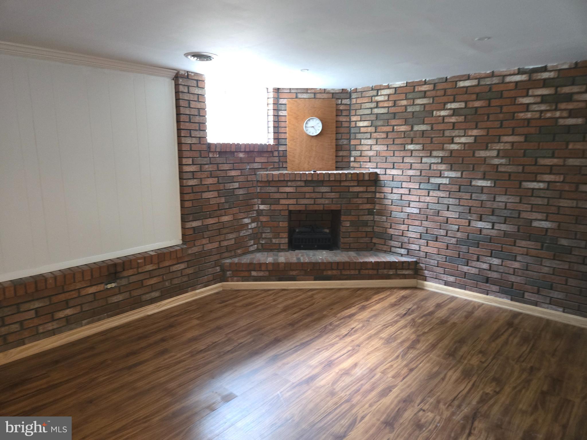 1850 Aberdeen Circle Crofton, MD 21114 - Photo 19 of 26 a view of an empty room with wooden floor and a fireplace