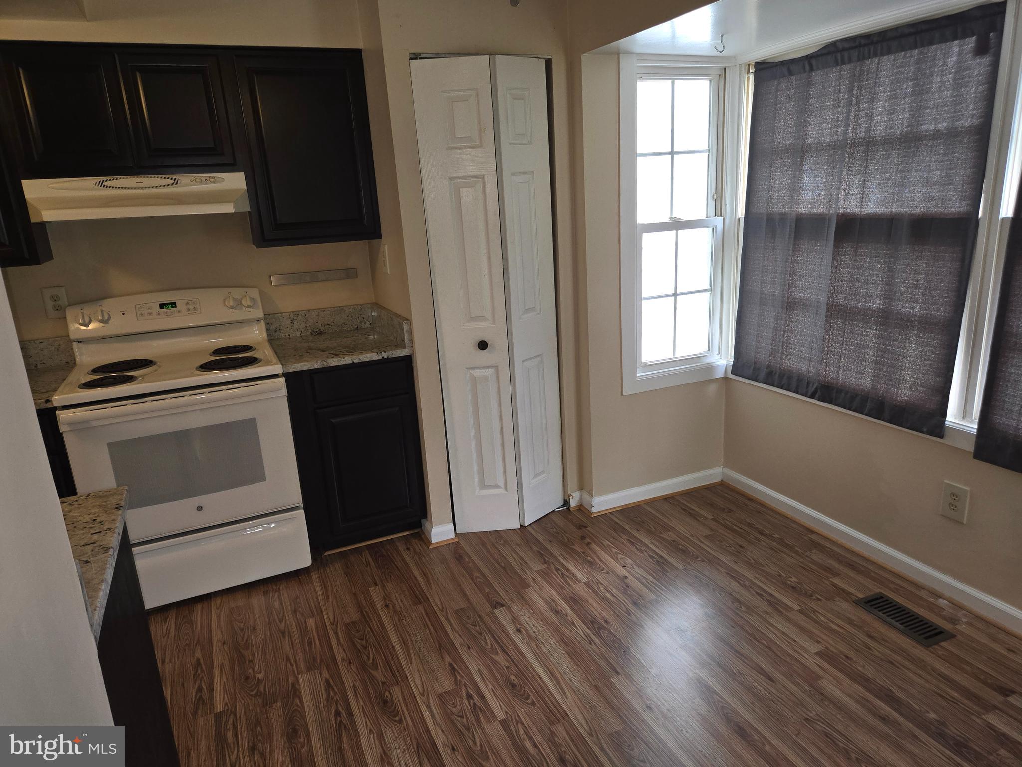 1850 Aberdeen Circle Crofton, MD 21114 - Photo 2 of 26 a kitchen with a wooden floor and a stove top oven
