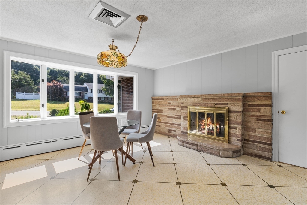 63 Sears Road Milton, MA 02186 - Photo 14 of 42 a view of a dining room with furniture wooden floor and a rug