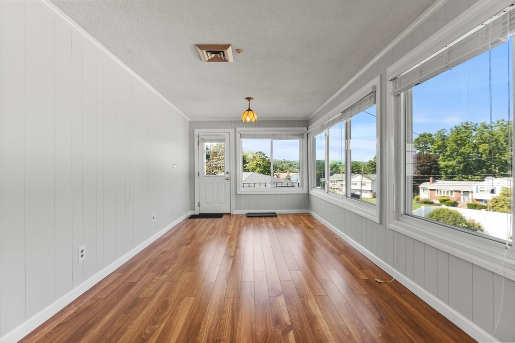 63 Sears Road Milton, MA 02186 - Photo 15 of 42 wooden floor in an empty room with a window