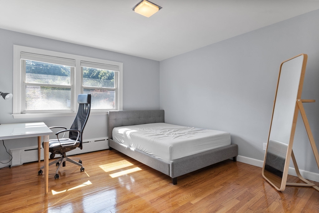 63 Sears Road Milton, MA 02186 - Photo 19 of 42 a bedroom with a bed and a desk