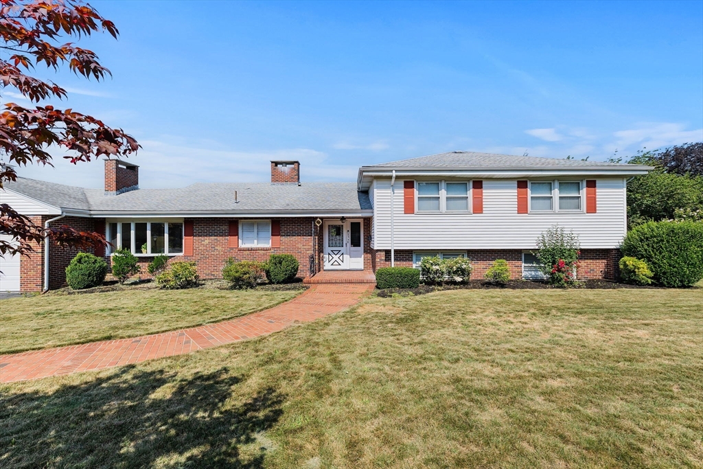 63 Sears Road Milton, MA 02186 - Photo 2 of 42 a front view of a house with a yard and garage