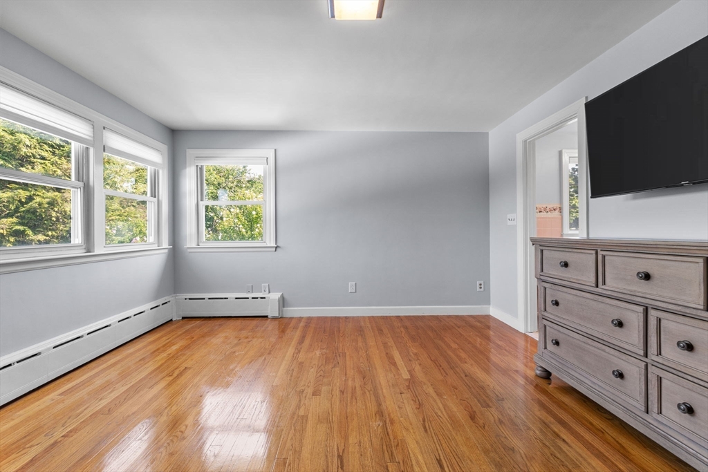 63 Sears Road Milton, MA 02186 - Photo 21 of 42 a view of a room with cabinet flat screen tv and windows