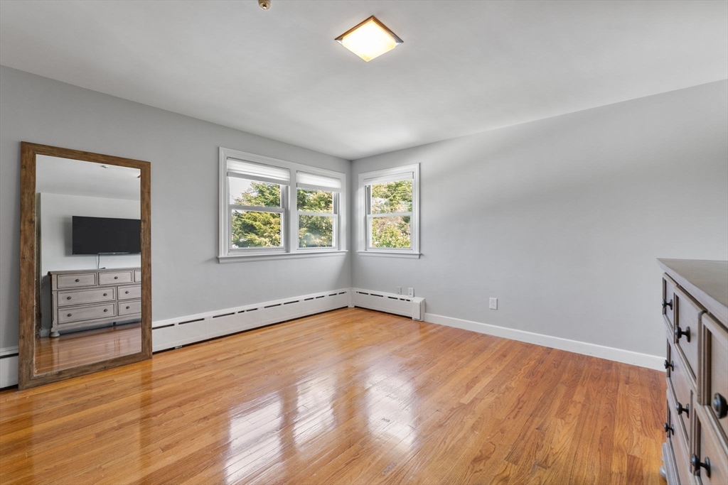 63 Sears Road Milton, MA 02186 - Photo 22 of 42 an empty room with windows and closet