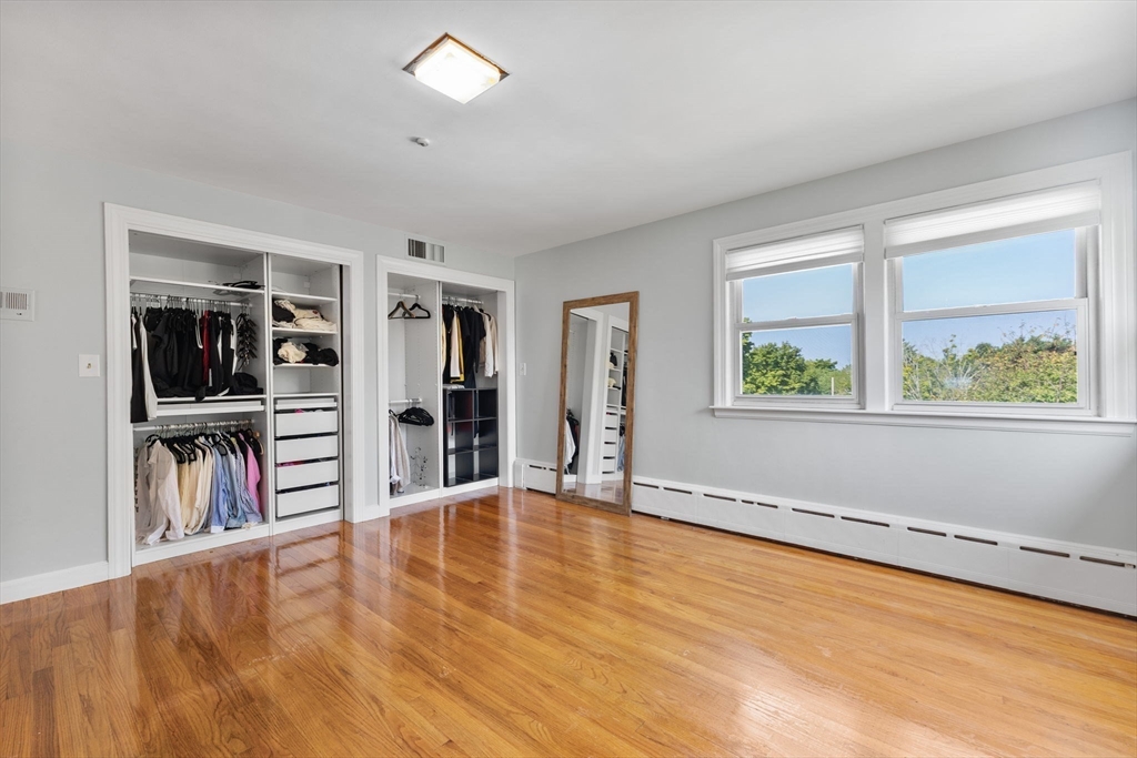 63 Sears Road Milton, MA 02186 - Photo 23 of 42 wooden floor in an empty room with a window