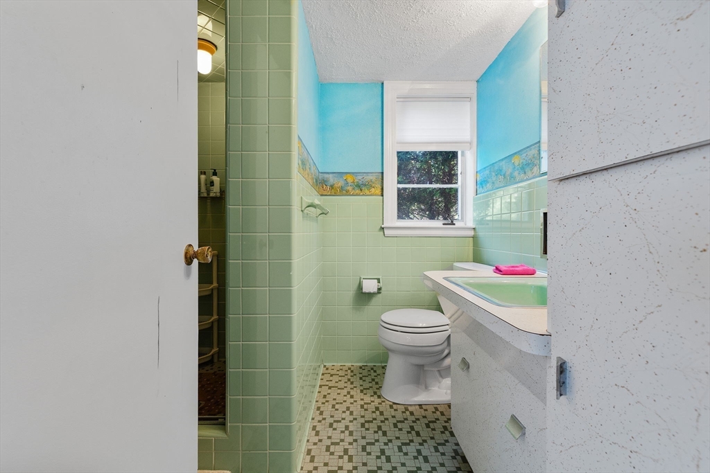 63 Sears Road Milton, MA 02186 - Photo 36 of 42 a bathroom with a toilet a sink and a shower